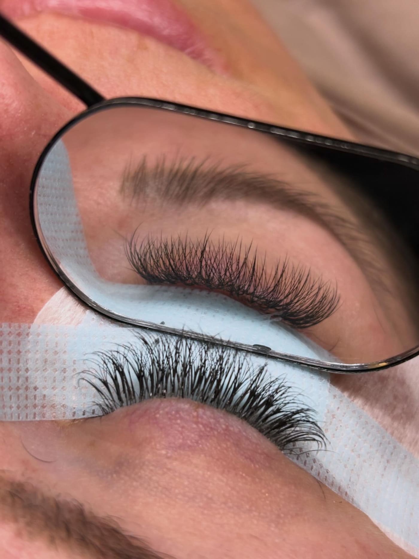 Ellie applying individual lash extensions during an appointment