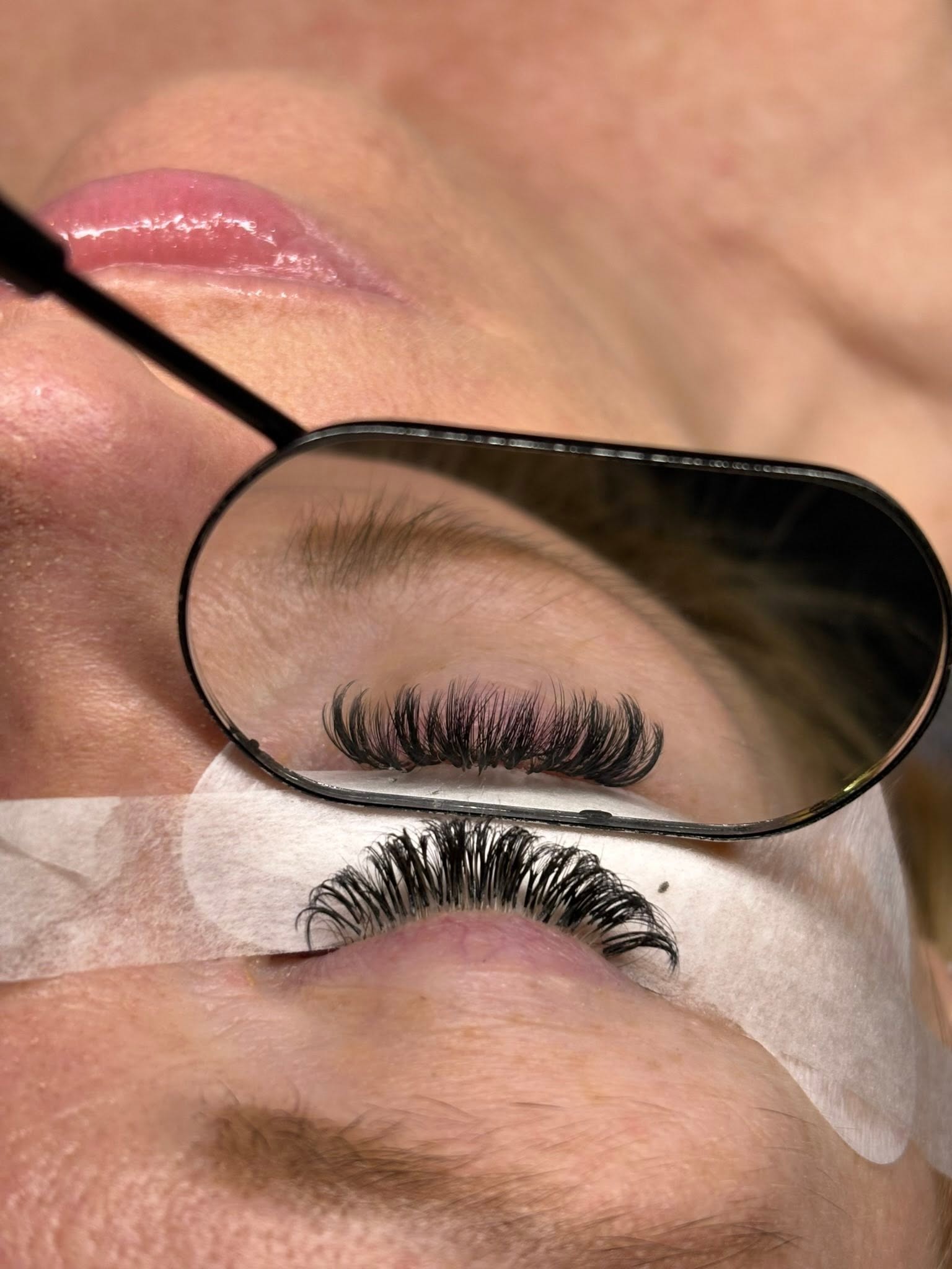 Full volume lash extension set by Ellie, mid-appointment mirror view